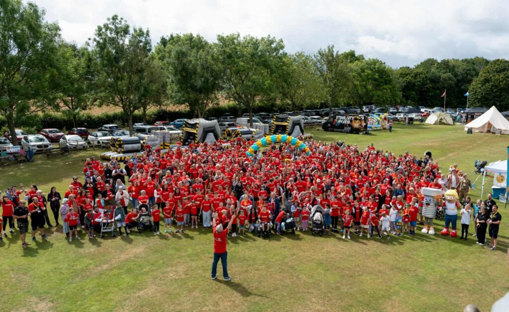 a group shot of 700 people all in red t shirts