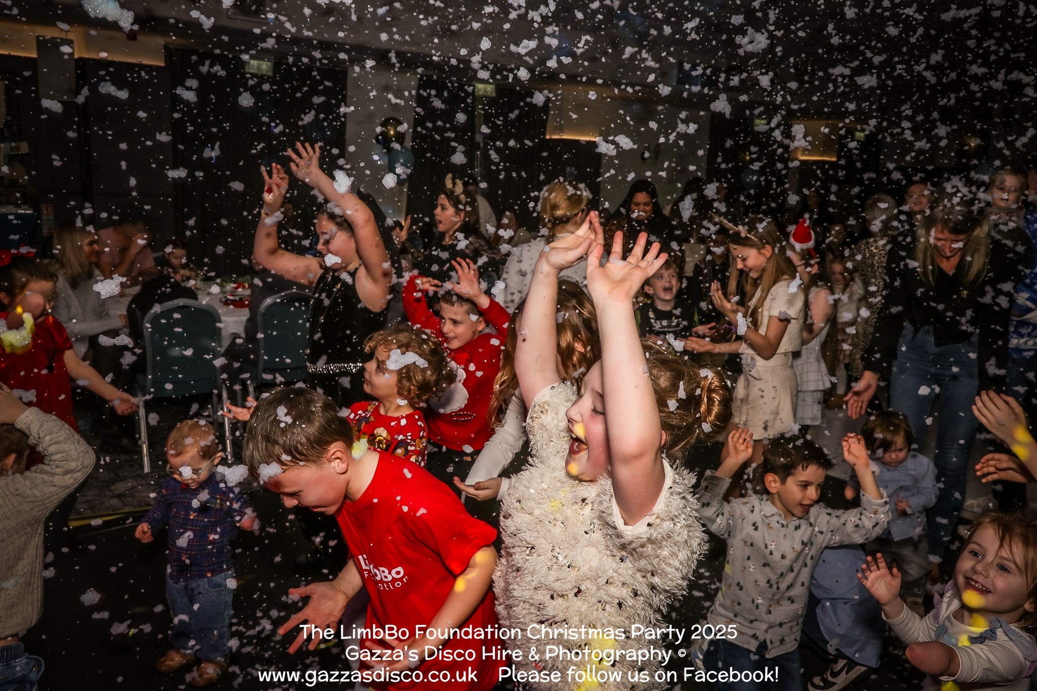 a party scene with lots of children and fake snow